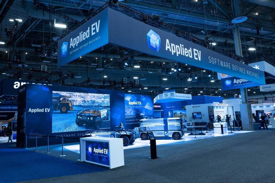 Applied EV 50x70 island booth at CES 2023 with a U-shaped hanging sign