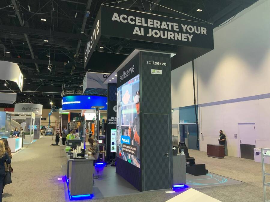 SoftServe's GTC booth with a tall lit tower and demo counters