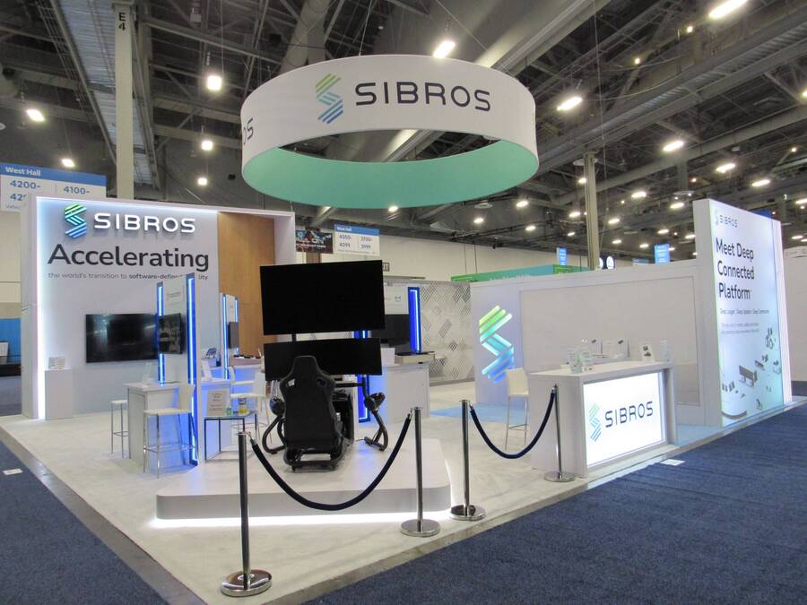 Sibros 40x40 island booth at CES 2024 with a ring-shaped hanging sign