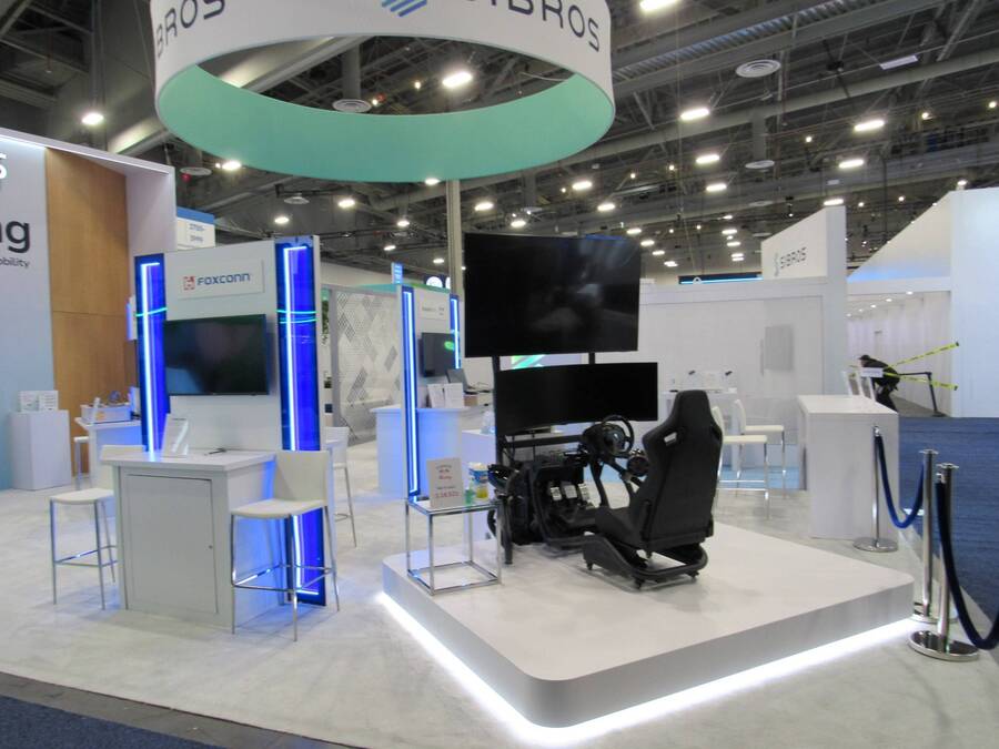 Car simulator on a lit platform in Sibros's CES 2024 booth