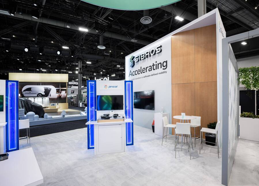 Demo stations with lit blue columns in Sibros's CES 2024 booth