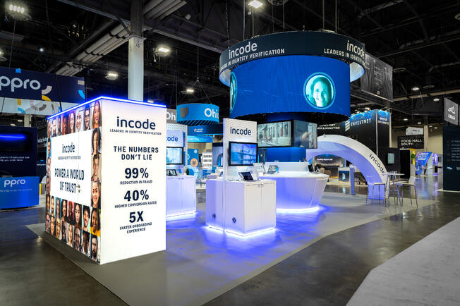 Incode's Money20/20 booth with a round LED header and stat graphics