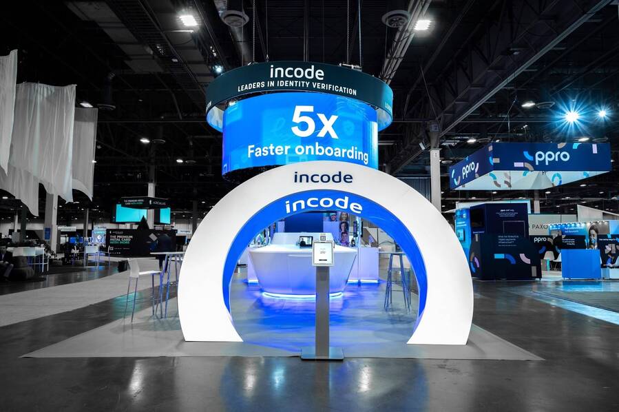 Lit arch entrance under a 5x Faster Onboarding LED sign in Incode's booth