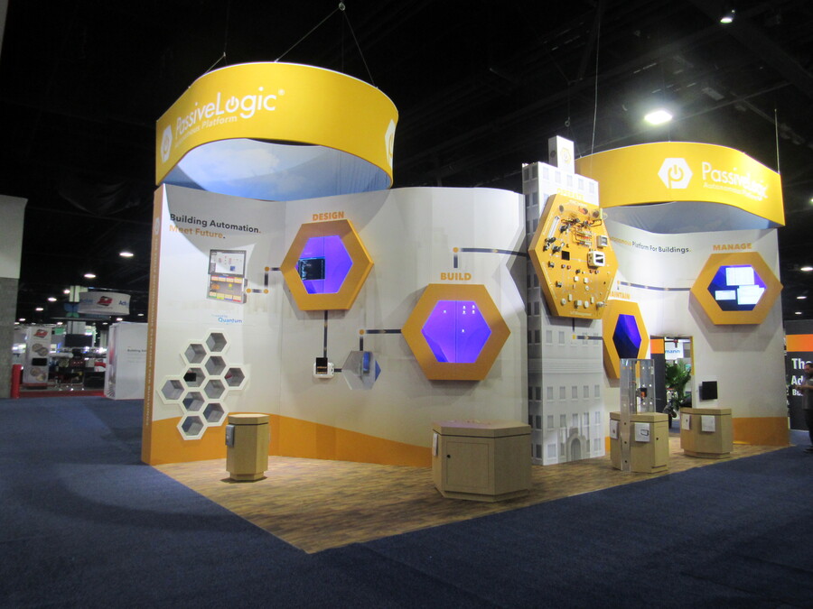 Curved walls and lit hexagon displays in PassiveLogic's AHR Expo booth