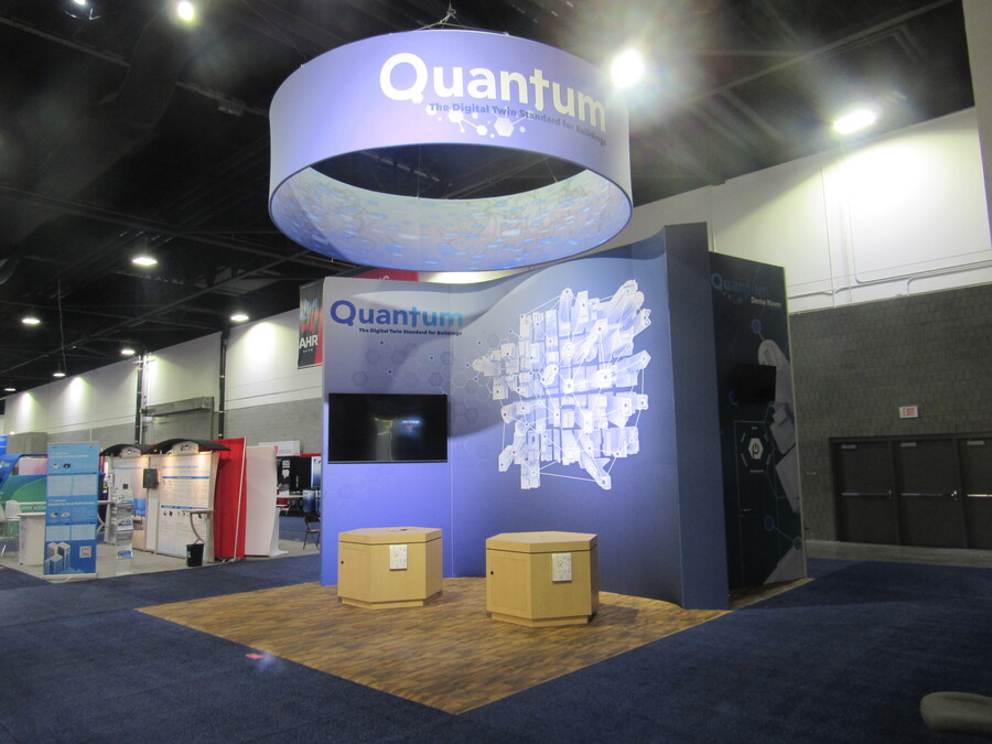 PassiveLogic's Quantum booth at AHR Expo with a round overhead sign