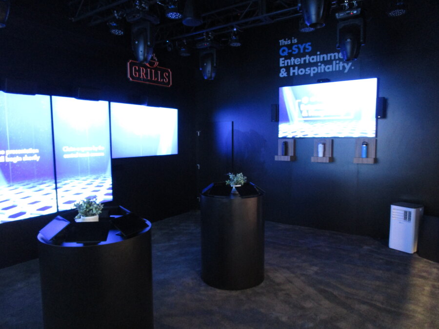 Entertainment and hospitality demo room with video walls in the Q-SYS booth